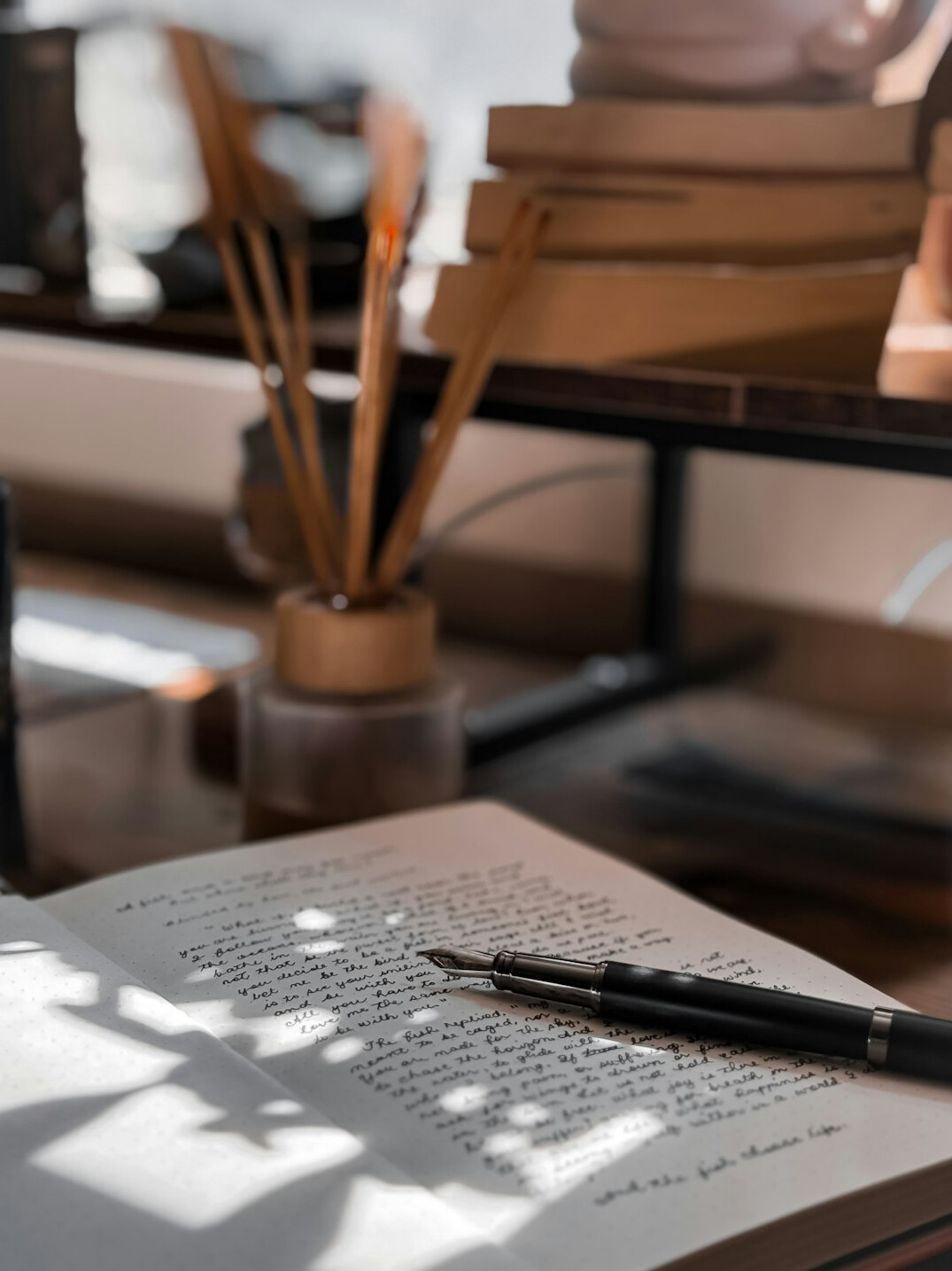 Wooden desk with notebooks and pens set up for a personal development workshop